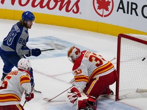 Maple Leafs forward William Nylander deposits the game-winning goal past Calgary Flames goaltender David Rittich during overtime at Scotiabank Arena in Toronto on Wednesday night.