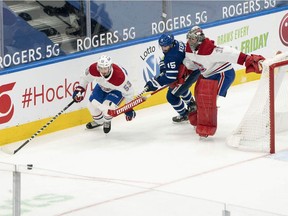 Maple Leafs' Alexander Kerfoot (15) battles with Canadiens goaltender Carey Price and defenceman Victor Mete (53) during the third period at Scotiabank Arena in Toronto on Saturday, Feb. 13, 2021.