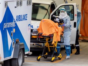 A paramedic transports a patient to Mount Sinai Hospital in Toronto, April 17, 2020.