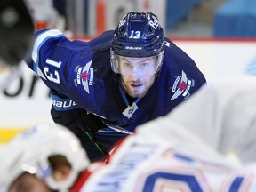 Winnipeg Jets forward Pierre-Luc Dubois is light up by arena lights during a face-off against the Montreal Canadiens in Winnipeg on Thurs., Feb. 25, 2021. Kevin King/Winnipeg Sun/Postmedia Network