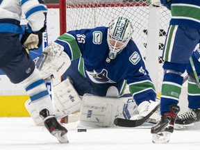 Thatcher Demko of the Canucks makes a save against the Winnipeg Jets during NHL action at Rogers Arena on March 22 in Vancouver.