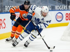 Edmonton Oilers’ James Neal (18) chases Toronto Maple Leafs’ Morgan Reilly (44) at Rogers Place in Edmonton on Wednesday, March 3, 2021.