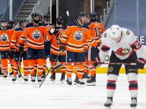 The Edmonton Oilers celebrate their 3-2 win over the Ottawa Senators during a NHL game at Rogers Place in Edmonton, on Monday, March 8, 2021.