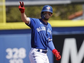 Blue Jays third baseman Cavan Biggio reacts to the dugout as he hits a RBI double during spring training.