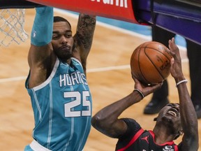 Charlotte Hornets forward P.J. Washington (25) comes in for a block on a shot by Toronto Raptors forward Chris Boucher (25) during the second quarter at Spectrum Center.