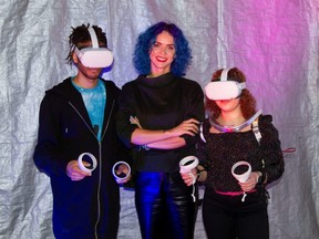 The founder of Raspberry Dream Labs, Angelina Aleksandrovich, poses for a photograph with Victoria Gillett and Aaron Vandeyar, who volunteered to experience cyber-intimacy through XR, a combination of virtual and augmented reality, haptic stimulators and scent, amid the COVID-19 pandemic, in London, England, Feb. 24, 2021.