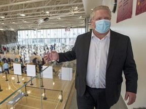 Ontario Premier Doug Ford tours a COVID-19 mass vaccination clinic in Toronto on Monday, March 8, 2021.