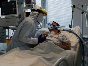 Health staff attends to a patient at the COVID-19 dedicated ICU unit of the Tras-Os-Montes E Alto Douro Hospital, in Vila Real, Portugal Feb. 22, 2021.