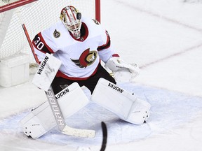 Goalie Matt Murray (30) stops a shot from the Calgary Flames.