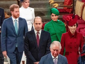 In this file photo taken March 9, 2020, Britain's Prince Harry, Duke of Sussex (left) and Britain's Meghan, Duchess of Sussex (second right) follow Britain's Prince William, Duke of Cambridge (centre) and Britain's Catherine, Duchess of Cambridge (right) as they depart Westminster Abbey after attending the annual Commonwealth Service in London.