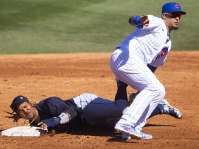 Cleveland Indians base runner Jose Ramirez slides into second base ahead of the tag by Chicago Cubs infielder Javier Baez at Sloan Park.