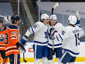 Maple Leafs’ William Nylander celebrates with teammates following his goal on Edmonton Oilers’ goaltender Mike Smith during the second period at Rogers Place in Edmonton on Wednesday, March 3, 2021.