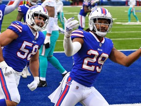 Buffalo Bills cornerback Josh Norman, right, reacts to his interception return for a touchdown with teammate outside linebacker Matt Milano against the Miami Dolphins during the third quarter at Bills Stadium in Orchard Park, N.Y., Jan. 3, 2021.