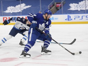 Maple Leafs defenceman Morgan Rielly (44) carries the puck in a game against the Winnipeg Jets on March 11. With the Leafs idle until Thursday, Rielly acknowledged getting antsy as the rest of the North Division teams go about their business.