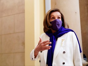 Speaker of the House Nancy Pelosi speaks to a reporter in the U.S. Capitol as the House takes up debate of the Senate's version of U.S. President Biden's COVID-19 relief plan in Washington, March 8, 2021.