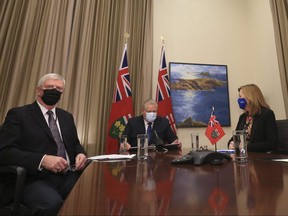 Retired General Rick Hillier, chair of the COVID-19 Vaccine Distribution Task force (L-R), Ontario Premier Doug Ford and Health Minister Christine Elliott on a conference call at Queens Park on February 26, 2021.