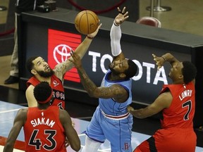 John Wall of the Rockets loses the ball to Raptor Fred VanVleet as teammates Kyle Lowry and Pascal Siakam look on during NBA action in Houston, Monday, March 22, 2021.