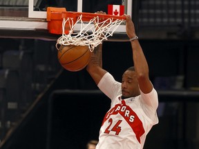 Toronto Raptors guard Norman Powell (24) dunks during the first half Wednesday at Amalie Arena in Tampa.