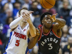 OG Anunoby of the Toronto Raptors and Luke Kennard, then of the Detroit Pistons, battle for the ball at Scotiabank Arena in Toronto on Oct. 30, 2019.