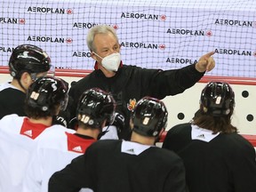 Calgary Flames head coach Darryl Sutter talks with players during practice on Wednesday, March 10, 2021.