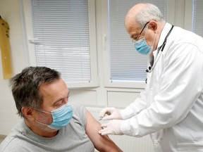 Family doctor Csaba Denes gives a dose of the Sinopharm coronavirus disease (COVID-19) vaccine to a patient, in Budapest, Hungary February 26, 2021.