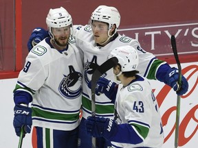 J.T. Miller (left), celebrating his overtime goal with Brock Boeser and Quinn Hughes, has had a tough run of late in his own zone with some ill-advised cross-ice exit passes that he would do best to eliminate from his game.