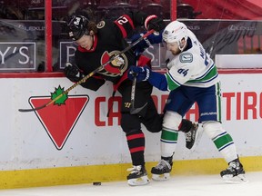 Ottawa Senators defenceman Nikita Zaitsev is taken off the puck by Vancouver Canucks centre Tyler Motte in the first period at the Canadian Tire Centre.