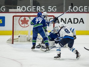 Mar 24, 2021; Vancouver, British Columbia, CAN; Winnipeg Jets forward Andrew Copp (9) scores a goal on Vancouver Canucks goalie Thatcher Demko (35) in the second period at Rogers Arena. Mandatory Credit: Bob Frid-USA TODAY Sports