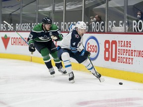 Vancouver Canucks forward Bo Horvat (53) checks Winnipeg Jets defenseman Neal Pionk (4) in the second period at Rogers Arena in Vancouver on Sunday, Feb. 21, 2021.