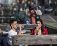 Shayne DeSilva and Brianna Rushlow enjoy the patio at Rivals Sports Pub along Danforth Ave. in Toronto, Ont., on Saturday, March 20, 2021.