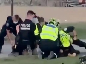 The Montreal police department says it's examining a video that circulated on social media on Sunday showing an officer holding a bearded man in a headlock on the ground and punching him next to Jeanne-Mance Park on Parc Ave.
