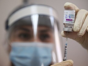 A medical worker fills a syringe with the AstraZeneca vaccine at a hospital in Tbilisi, Georgia March 16, 2021.