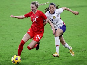 Gabrielle Carle (No. 14) of Canada controls the ball against Christen Press (No. 23) of United States during the SheBelieves Cup at Exploria Stadium on February 18, 2021 in Orlando, Florida.