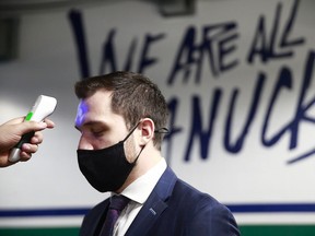 Bo Horvat of the Vancouver Canucks gets a temperature check before their NHL game against the Toronto Maple Leafs at Rogers Arena on March 6, 2021 in Vancouver, British Columbia, Canada.