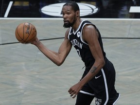 Kevin Durant of the Brooklyn Nets dribbles the ball during the first half against the Golden State Warriors at Barclays Center on December 22, 2020 in the Brooklyn borough of New York City.