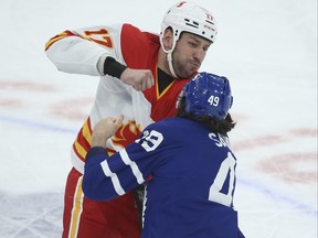 Calgary Flames' Milan Lucic fights Toronto Maple Leafs' Scott Sabourin during Tuesday's game.