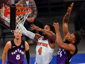 Derrick Rose of the New York Knicks attempts a shot as Khem Birch of the Toronto Raptors (right) defends earlier this month.