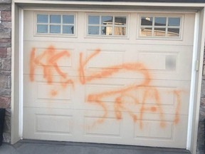 Racist graffiti spray-painted on a garage door in the Royal Oak area.