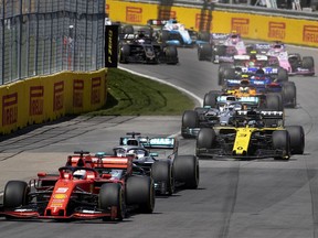 Scuderia Ferrari Mission Winnow driver Sebastian Vettel (5) of Germany leads the crowd in to the first turn during the Canadian Grand Prix at the Circuit Gilles Villeneuve in 2019.