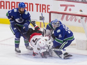 Ottawa Senators forward Brady Tkachuk (7) collides with Vancouver Canucks defenceman Jordie Benn (8) and goalie Thatcher Demko (35) in the third period at Rogers Arena in Vancouver on Jan. 27, 2021. Vancouver won 5-1. Mandatory Credit: Bob Frid-USA TODAY Sports ORG XMIT: IMAGN-445015