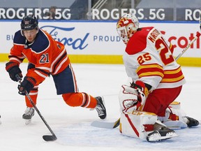 Edmonton Oilers forward Dominik Kahun (21) tries to take shot against Calgary Flames goaltender Jacob Markstrom (25) during the first period at Rogers Place on April 2, 2021.