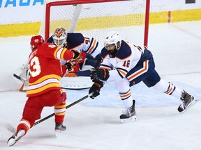 Calgary Flames forward Sam Bennett gets a shot on Edmonton Oilers goaltender Mike Smith and as Oilers defenceman Jujhar Khaira reaches in during NHL action at the Scotiabank Saddledome in Calgary on Saturday, April 10, 2021. Gavin Young/Postmedia