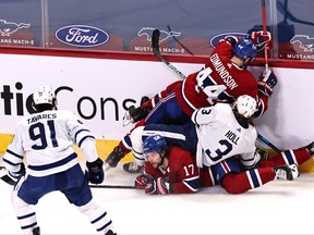 Canadiens' Joel Edmundson (44) and Maple Leafs' Justin Holl fall on Habs' Josh Anderson and Leafs' John Tavares during the second period at the Bell Centre in Montreal on Monday, April 12, 2021.