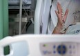 A Brazilian COVID-19 patient holds up a rosary in a hospital in Belem, Brazil in April, 2021.