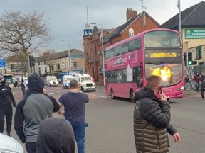 A bus is set on fire as protesters demonstrate on Shankill Road in Belfast, Northern Ireland, April 7, 2021. in this picture obtained from social media.