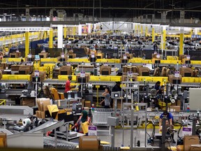 People work inside the Amazon fulfillment centre in Brampton on Friday, July 21, 2017.