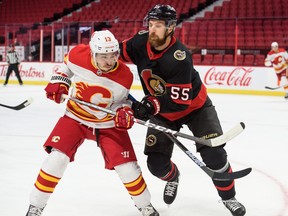 Ottawa Senators defenceman Braydon Coburn (right) stays close to Johnny Gaudreau of the Calgary Flames during a game on March 1. Coburn, with 979 games under his belt, could be of interest to teams at the trade deadline.