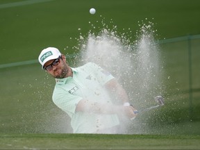 Canada's Corey Conners plays out from the bunker onto the second green during the third round of The Masters at Augusta, Ga., on Saturday, April 10. BRIAN SNYDER/REUTERS