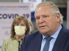 Ontario Premier Doug Ford speaks during the daily briefing at a mass vaccination centre in Toronto on Tuesday, March 30, 2021.