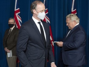 Adalsteinn Brown, co-chair of Ontario's COVID-19 science advisory table, centre, with Dr. David Williams, left, and Ontario Premier Doug Ford at Queen’s Park in Toronto on April 1, 2021.